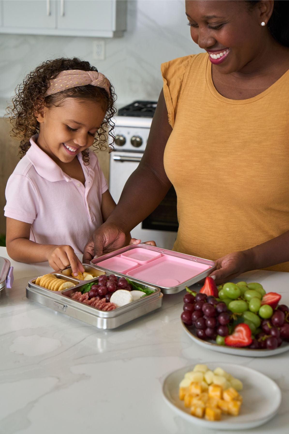 Woman and child preparing a healthy lunch using a Good Bare stainless steel lunch box