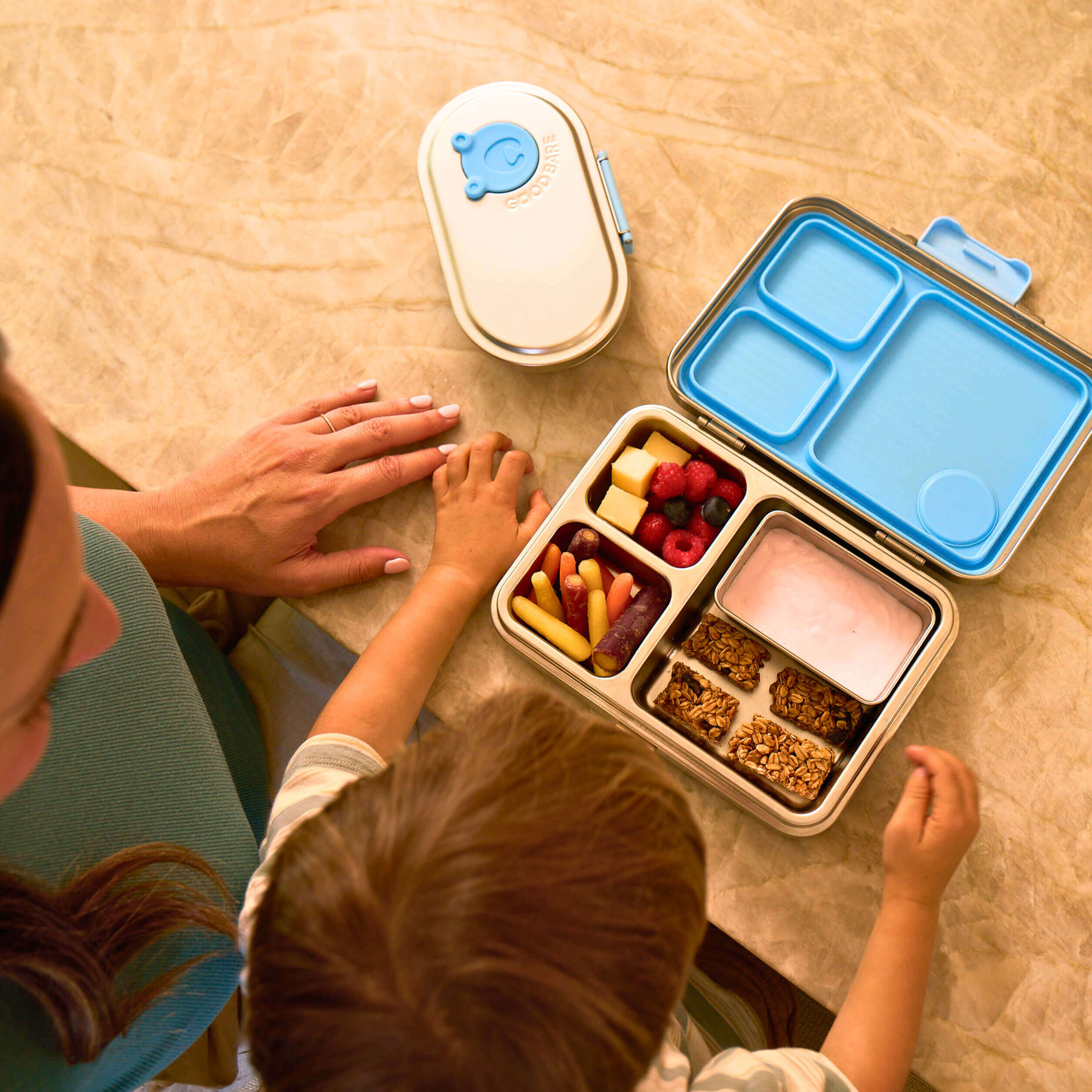 Family prepare lunch for school using Good Bare leakproof stainless steel lunch box