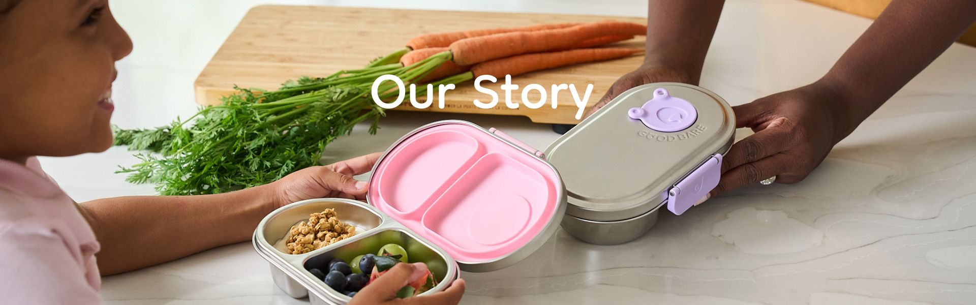 Mom and child in a kitchen preparing food with leakproof stainless steel snack boxes.