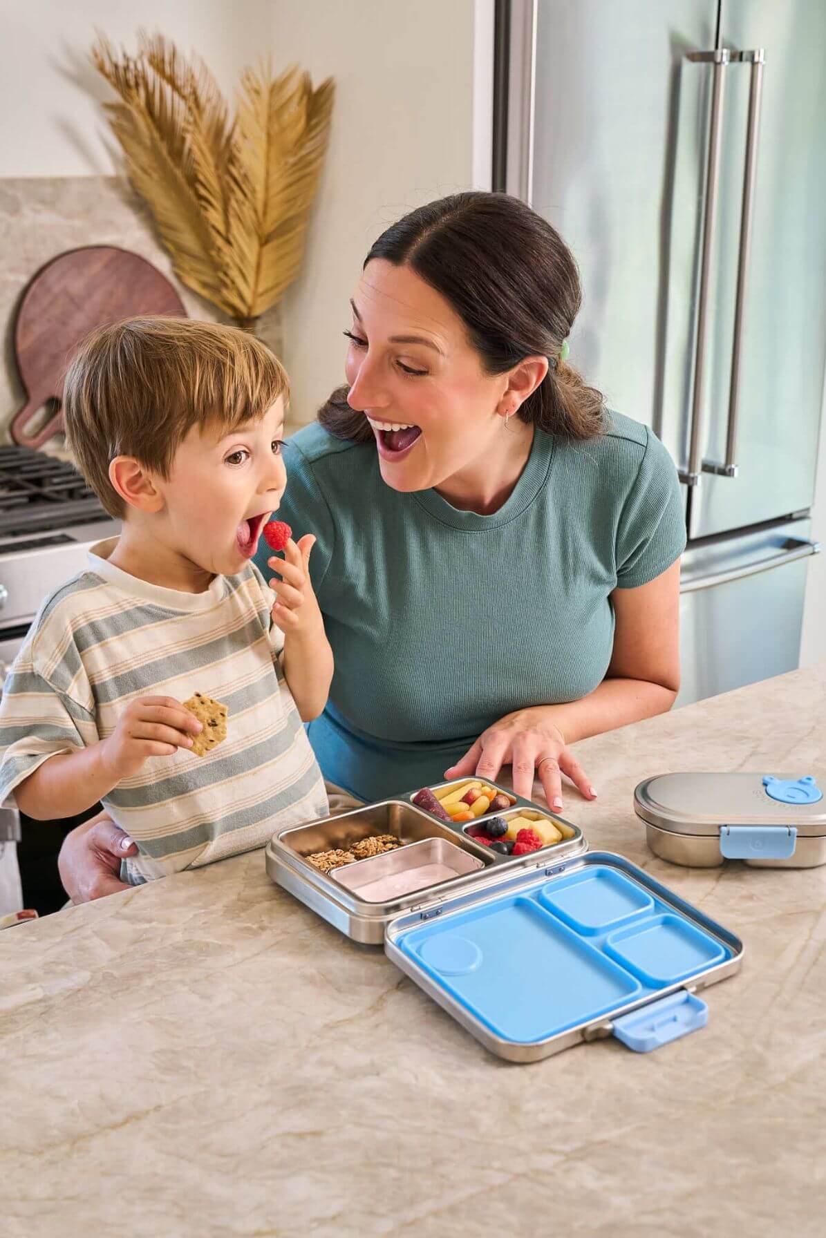 Family preparing lunch in a kitchen using Good Bare stainless steel bento containers 
