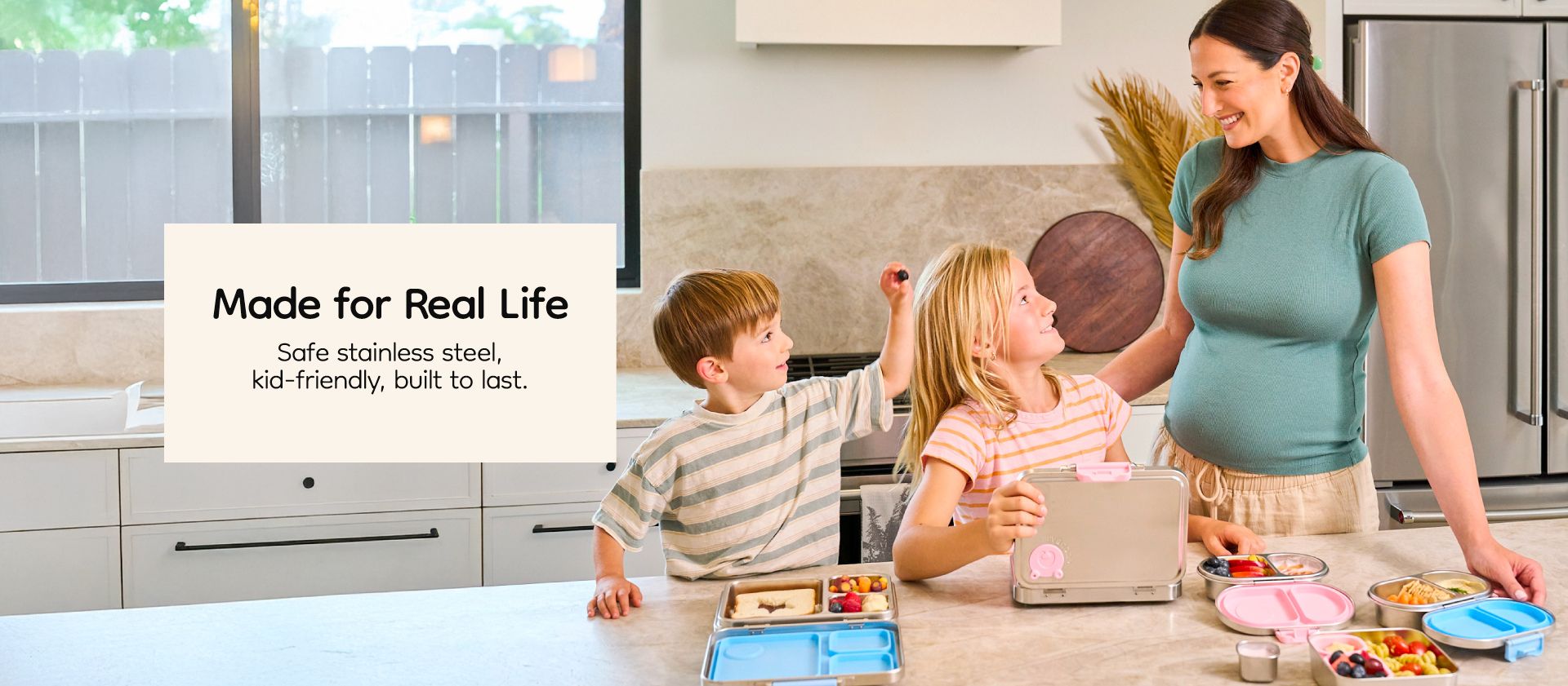 Mother and kids using Good Bare stainless steel lunch box in kitchen